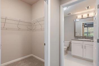 a bathroom with a toilet and a sink and a mirror at The Enclave at Crossroads, North Carolina, 27606
